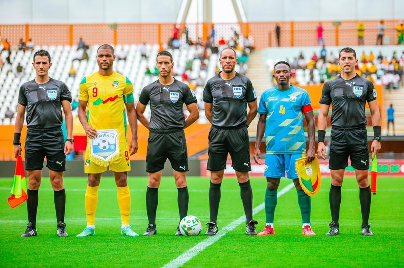 Benin and Rwanda skippers Steve Mounie and Djihad Bizimana poses for a photo with match officials